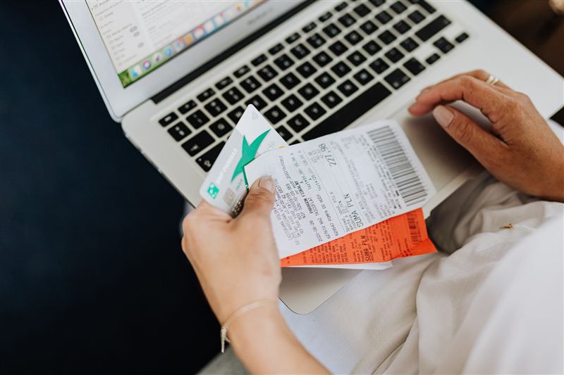 Receipts and a bank card in front of a laptop
